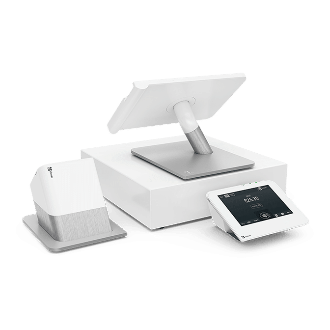 A Clover point-of-sale system with a tablet display, payment terminal, and receipt printer in white and silver.
