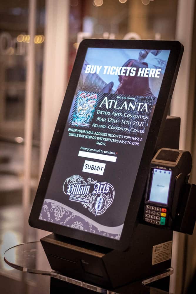 a ticketing self-service kiosk with a credit card reader attached