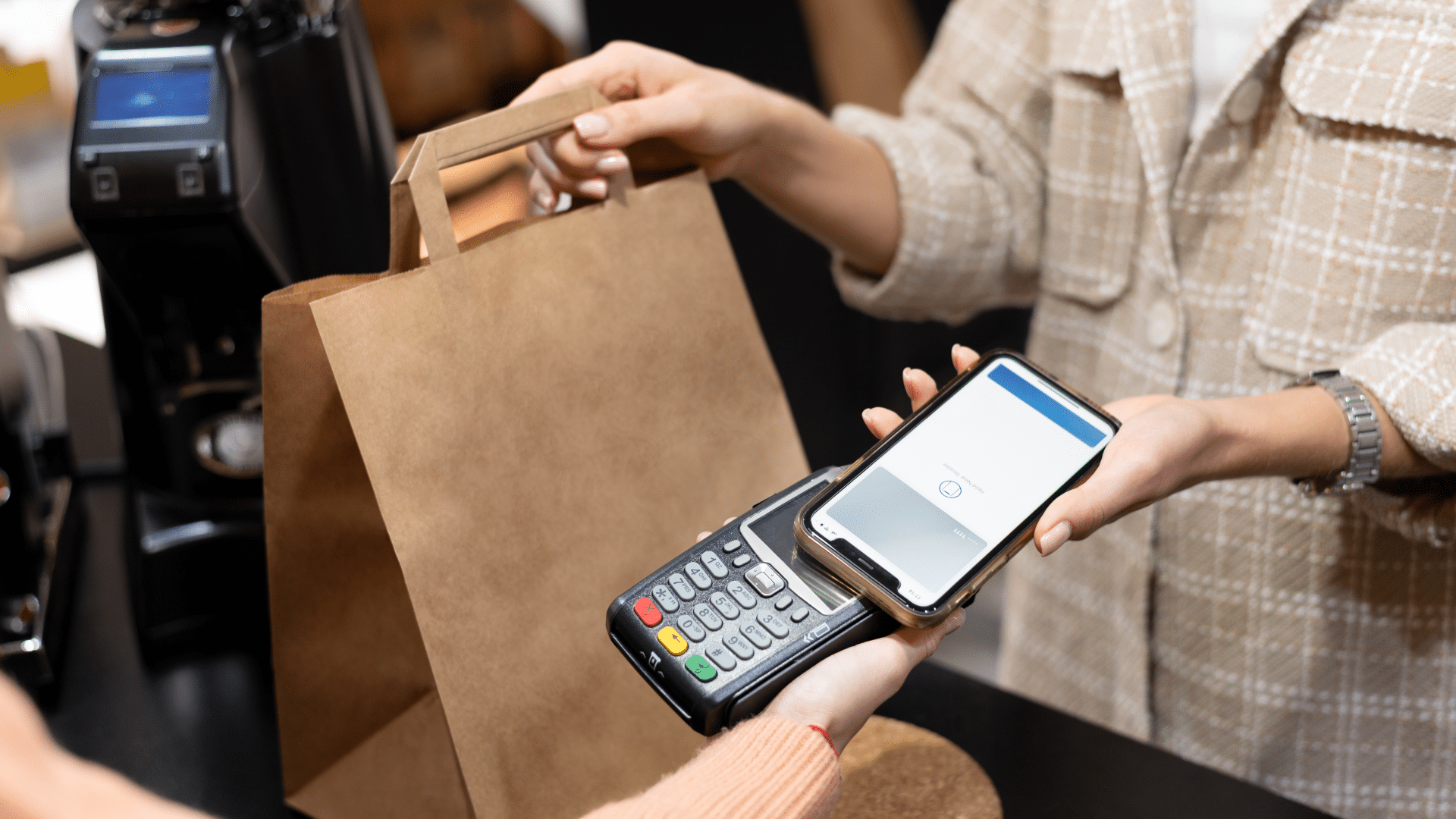 Customer uses a contactless payment through their smartphone to make a purchase at a retail store