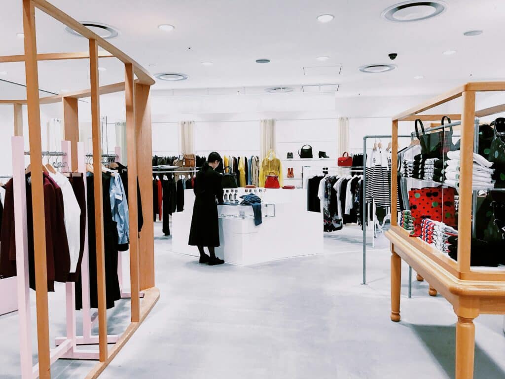 Inside of a small boutique apparel store in Japan with a sleek clean design