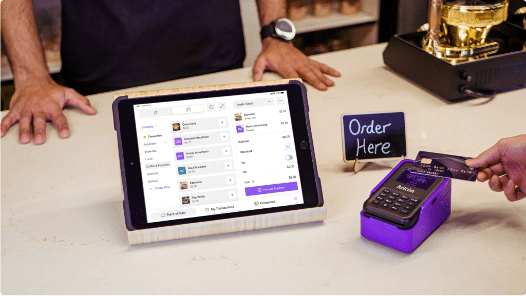 Picture illustrating a customer completing a purchase through Helcim. 