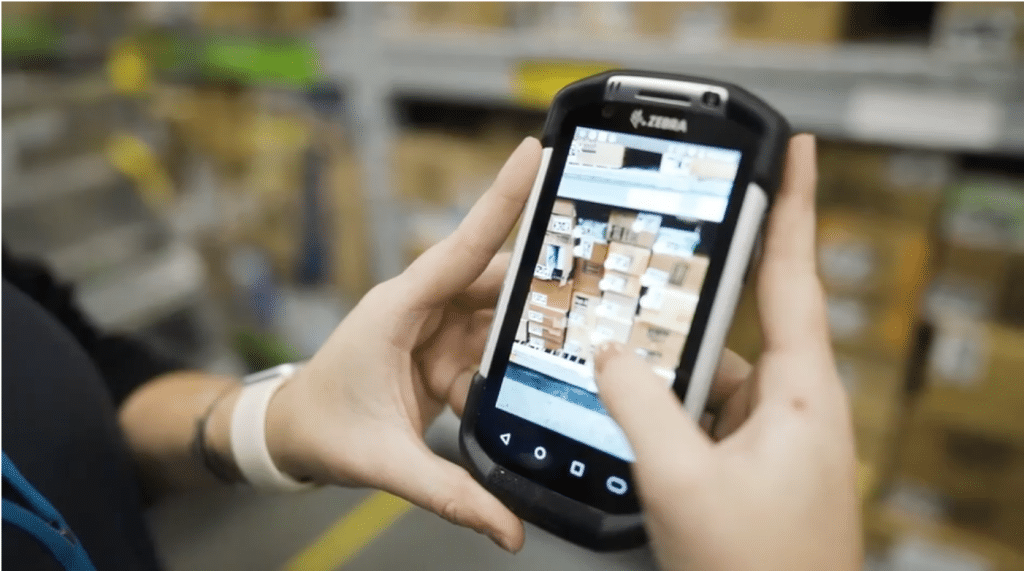 walmart holding a handheld mobile pos device