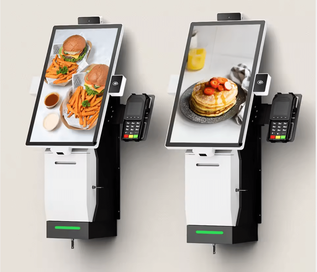 Image of two self-checkout kiosks at Burger King attached to a wall