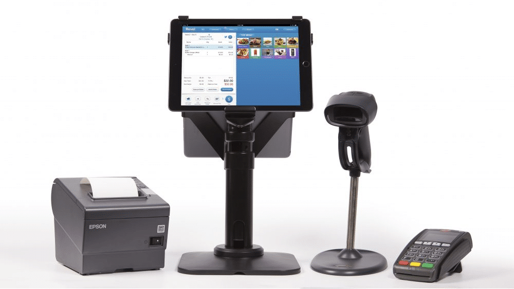 Revel Systems POS hardware stack, including an iPad and stand, receipt printer, barcode scanner, and payment terminal