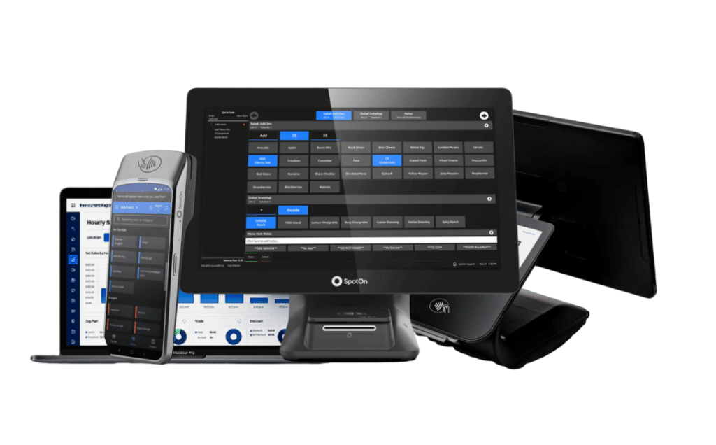 The SpotOn point-of-sale system featuring a central touchscreen terminal displaying a salad modifier screen, a handheld device, a laptop, and a payment terminal, all in black.